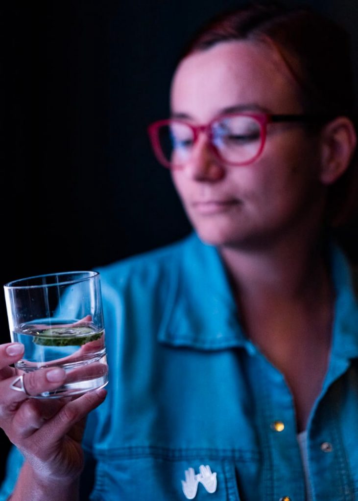 woman inspecting glass of mineral water